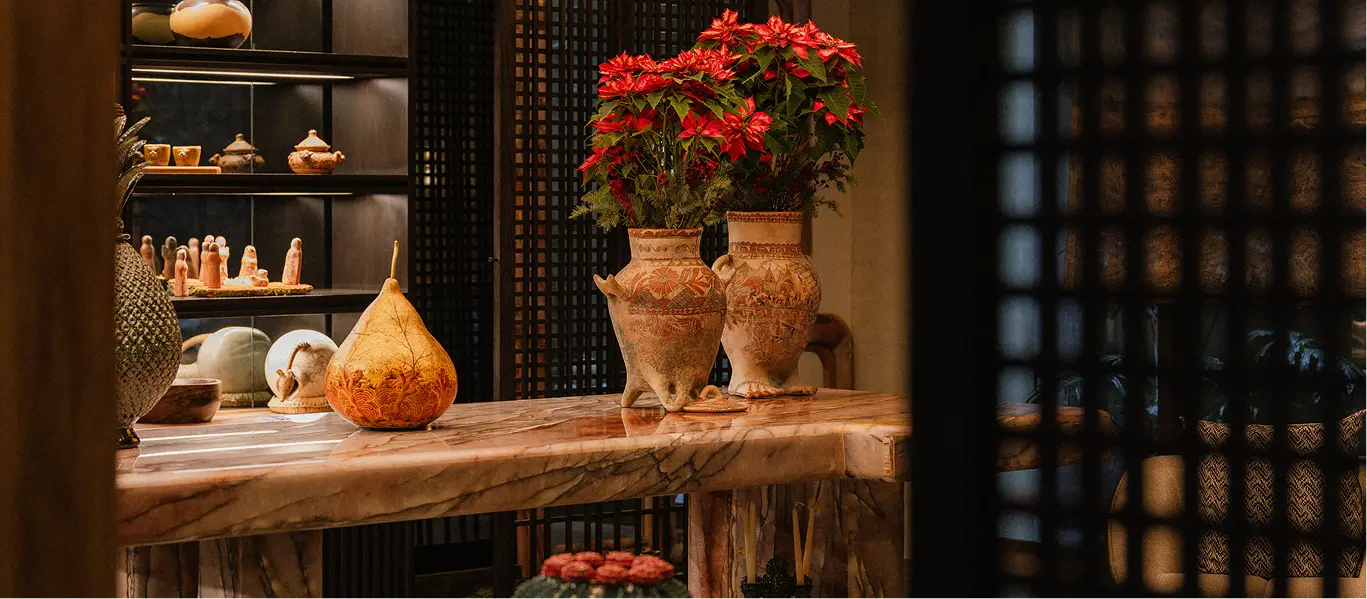 Marble console with clay vases and poinsettias at Colima 71